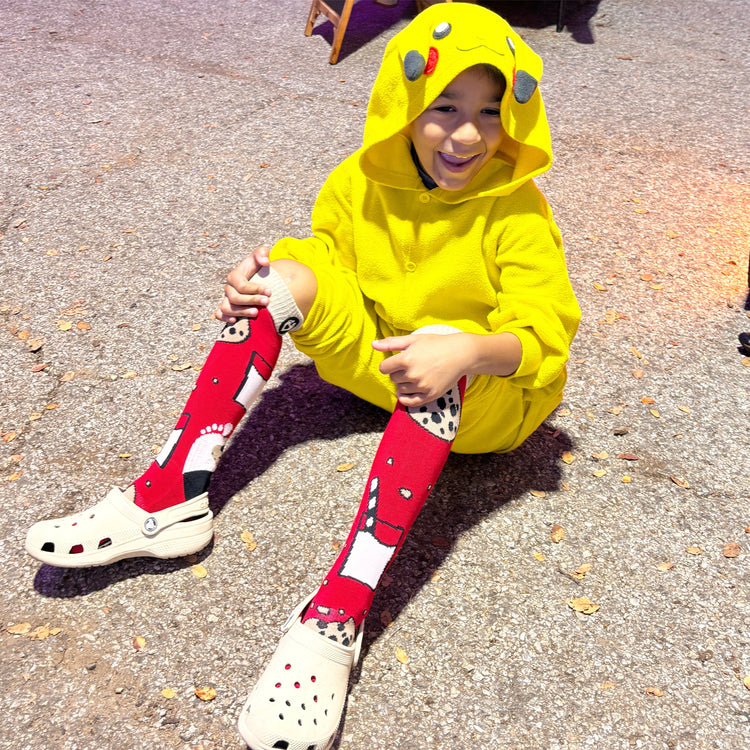 Children sitting in on rocks in Avondale Birmingham, Alabama modeling SoleMate Sox