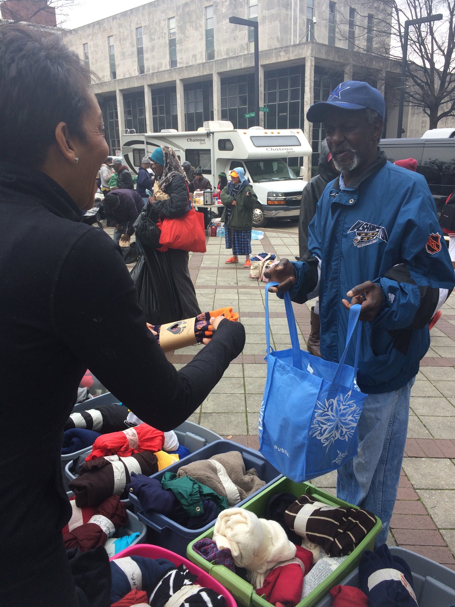 SoleMate Sox CEO Catenya McHenry offers a pair of SoleMate Sox to a homeless man in downtown Birmingham, AL during a Be a Blessing charity event.